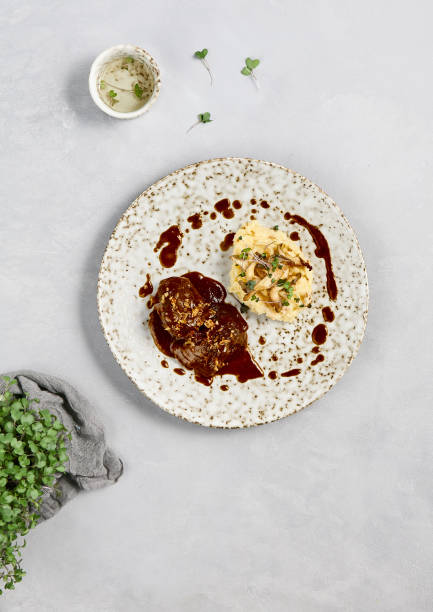 istock Gourmet Beef Cheeks with Demi-Glace Sauce and Creamy Mashed Potatoes on Modern Plate 2167220727