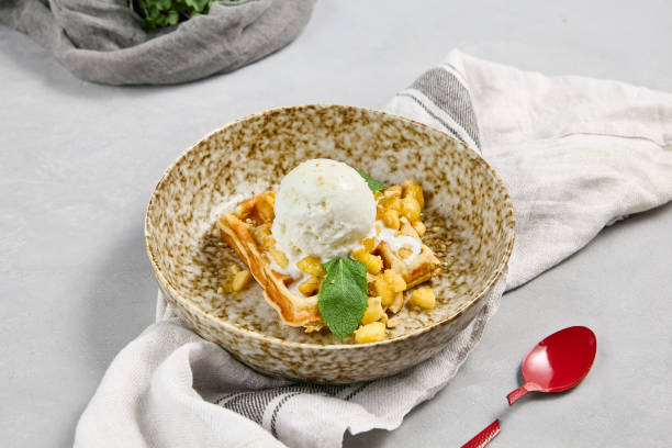 istock Viennese Waffle with Pears and Ice Cream on a Rustic Plate with Red Spoon 2167222232