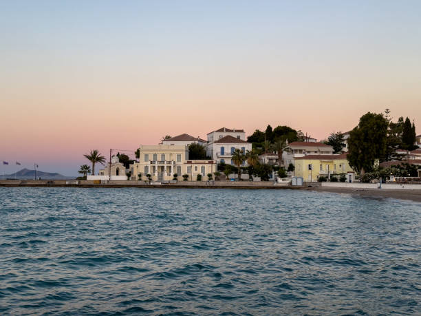 Spetses island, Greece. Seafront neoclassical buildings, old historic town, at sunset
