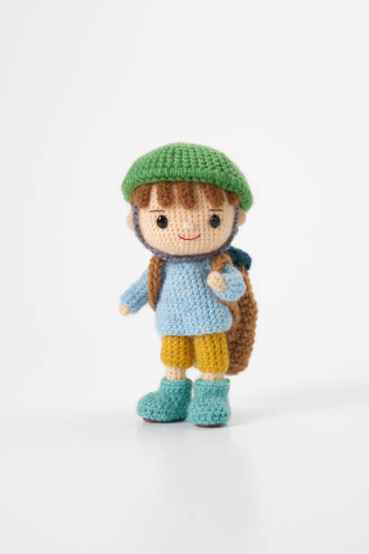 istock Small and cute Amigurumi doll on white background.Disaster prevention training 2167224740