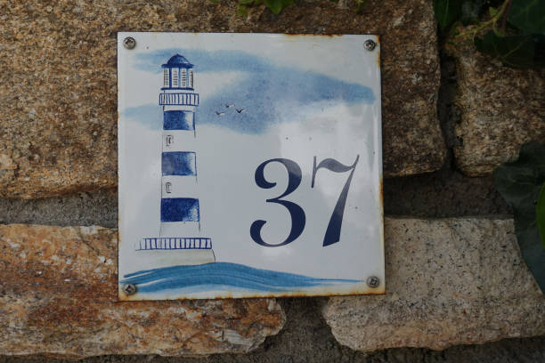 Old street sign number 37 decorated with a lighthouse