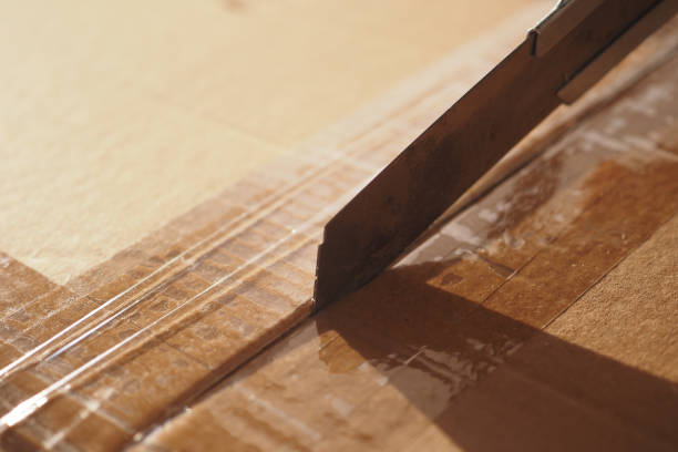 istock Utilizing a Cutting Tape on a Cardboard Box During the Process of Unpacking Items Carefully 2167226977