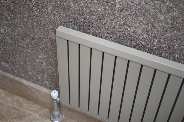 istock White radiator on grey white wall. apartment heating installation system, 2167227897