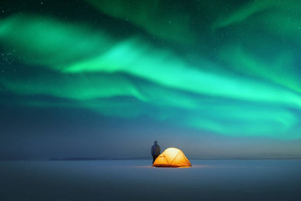 istock Tourist near yellow tent lighted from the inside 2167228433