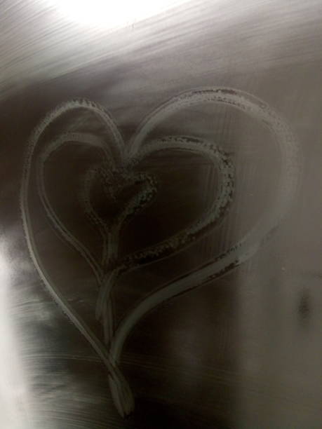 istock Heart-shaped steam pattern on glass with soft light background, symbolizing love and romance. 2167229389