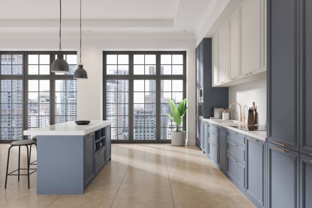 istock White and blue home kitchen interior with bar island and cabinet, window 2167231230