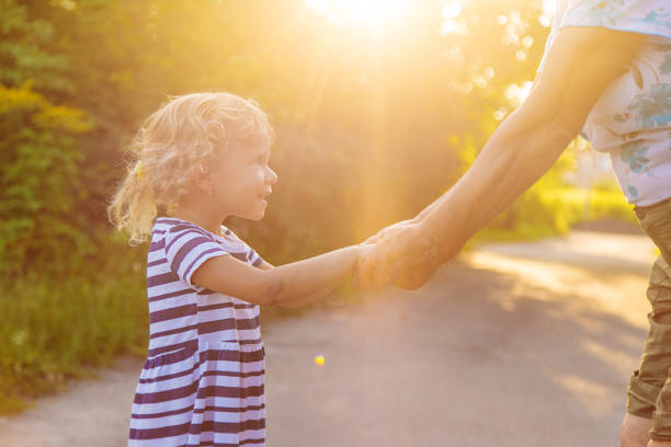 Parent and child across the crosswalk holding hands