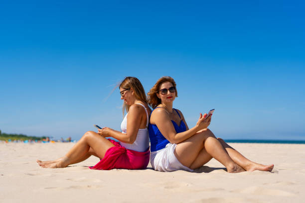 istock Mature women enjoying beach holiday 2167232997