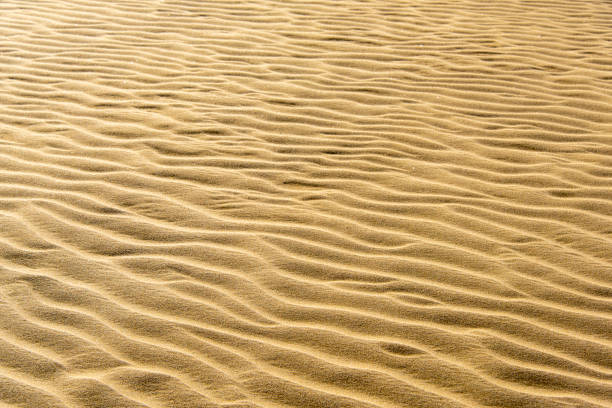 Water ripples in golden tones. Abstract background and texture for design.