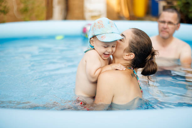istock Cheerful family having great time together in wading pool 2167235832