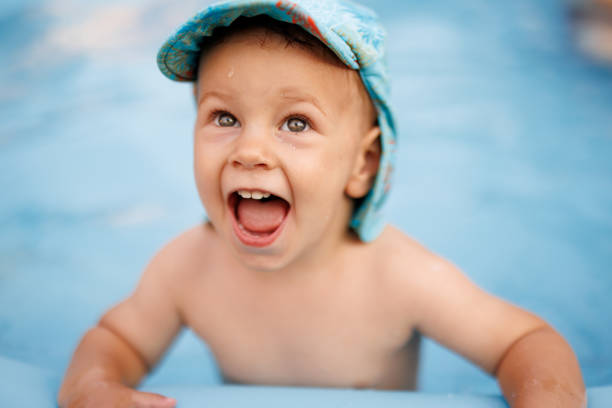 Portrait of excited  baby boy in wading pool