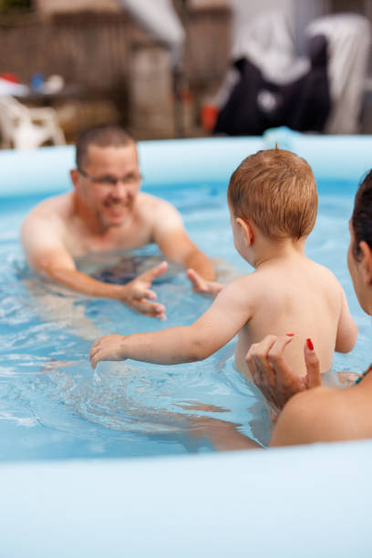 istock Cheerful family having great time together in wading pool 2167235977