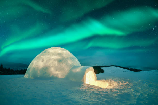 istock Wintry scene with glowing polar lights and snowy igloo 2167236185