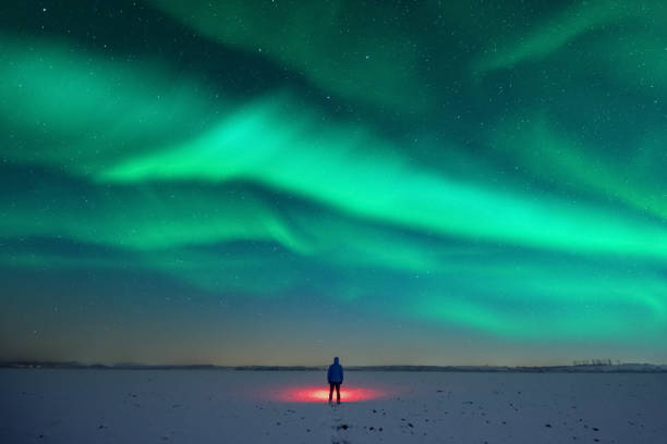 istock Tourist with red flashlight on snowy field 2167236379