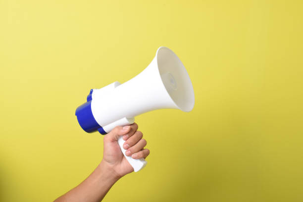 istock Close up hand holding megaphone. Concept of hiring. Copy space 2167236383