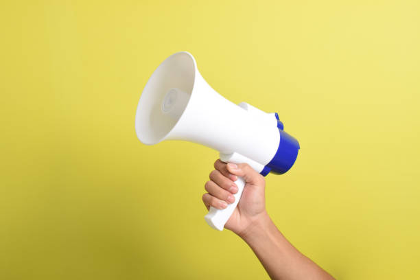 istock Close up hand holding megaphone. Concept of hiring. Copy space 2167236403