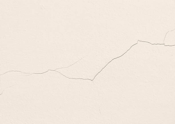 istock Dirty cream cracked concrete wall texture background. 2167243275