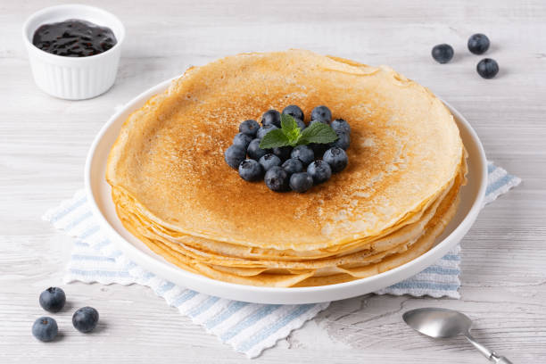 istock Crepes, thin pancakes with blueberry jam and fresh berries 2167243781