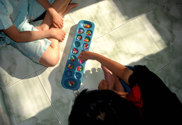 Congklak is a traditional Indonesian game played with a board with holes and seeds.
