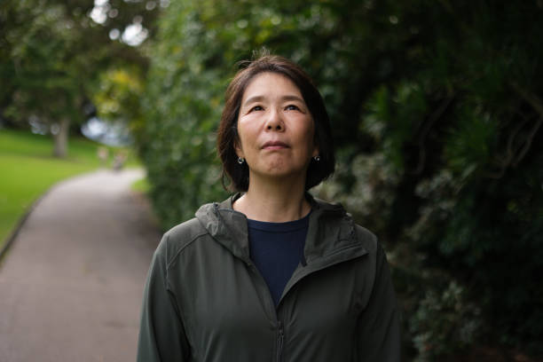 istock Asian woman outdoors, looking up 2167246335
