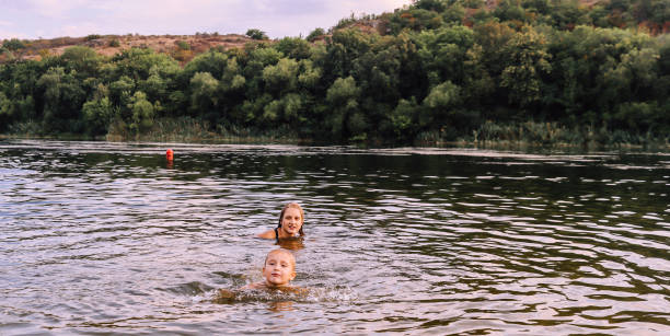istock Children swimming in the river on a summer evening 2167247175