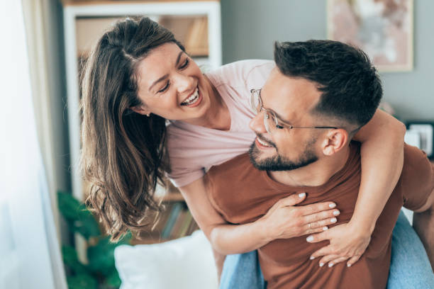 istock Young happy couple piggybacking at home 2167247242
