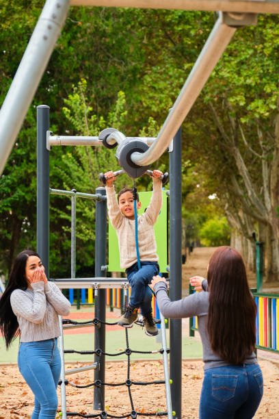 istock Lesbian couple scared because their son is playing in the zip line. 2167248400