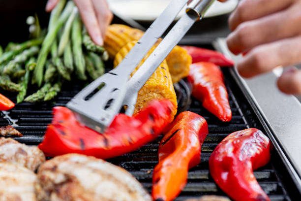 istock Grilled chicken meat with vegetables on barbecue grill with smoke. 2167251064