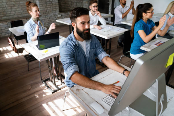 istock Successful happy group of people learning software engineering and business during presentation 2167251802