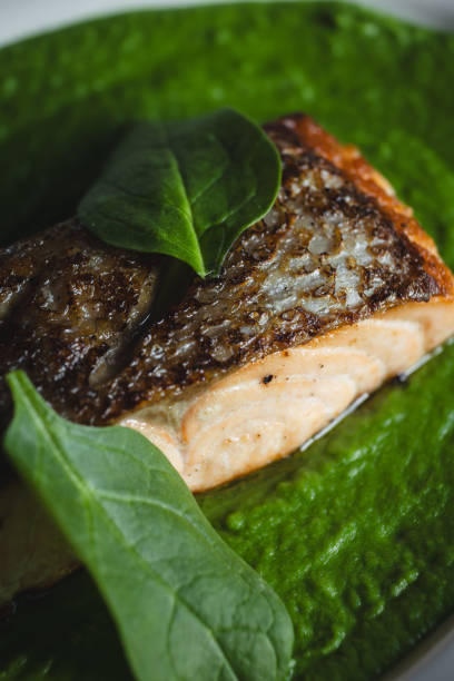istock Appetizing salmon fillet with spinach and herbs. Restaurant food service, dish presentation 2167253273