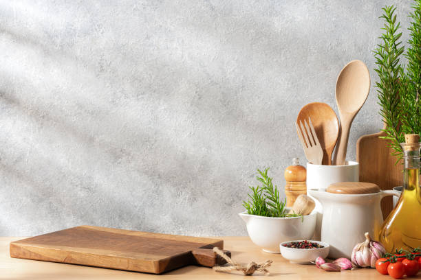 istock Cutting board and kitchen utensils on wooden kitchen counter. Copy space. 2167253717