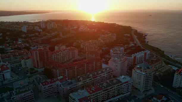 istock Drone bright sunset shining on resort town. Ocean surface reflecting sunlight 2167253924
