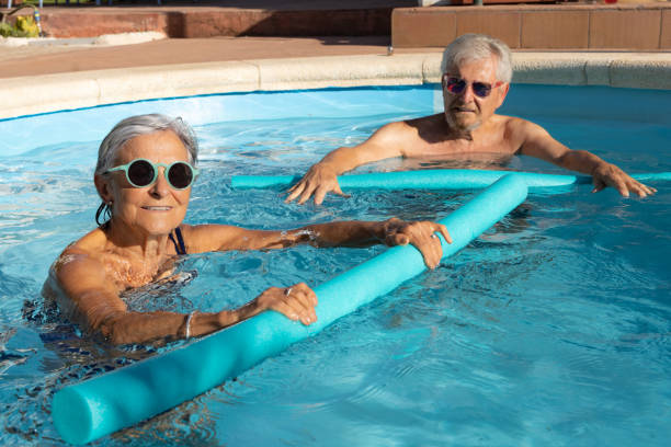 istock Senior Couple Enjoying a Fun Pool Workout Together 2167254579