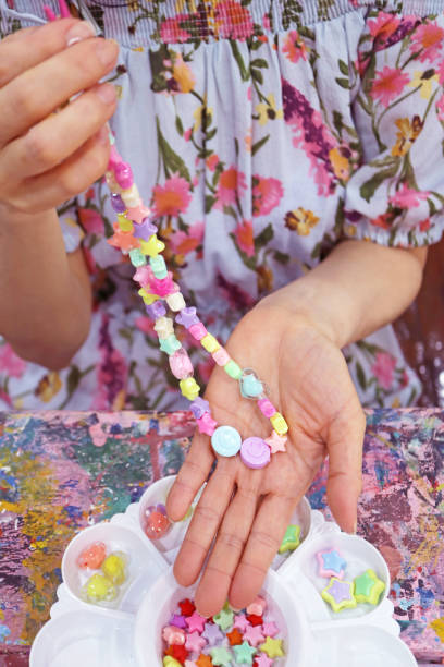 istock Woman just Finished Making her Pastel Color DIY Beaded Necklace Workshop 2167256362