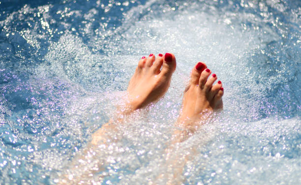 istock Stunningly painted toenails on a woman's feet while enjoying a hydromassage session in the pool 2167257546