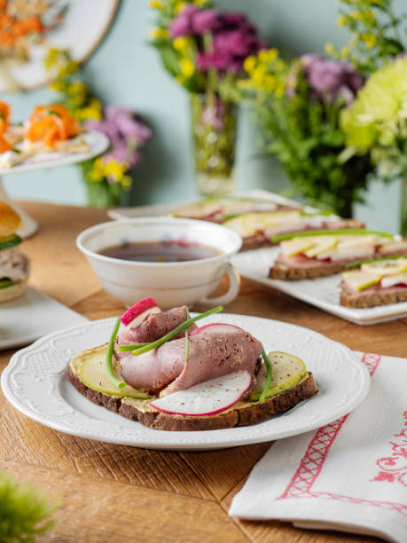 Bruschetta with meat. Tapas. Artisan Smoked Meat Sandwich. Bread with prosciutto. Smoked meat sandwich. Tartines. Sandwich with tea. Sandwich.