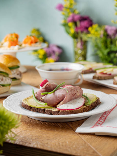 Bruschetta with meat. Tapas. Artisan Smoked Meat Sandwich. Bread with prosciutto. Smoked meat sandwich. Tartines. Sandwich with tea. Sandwich.