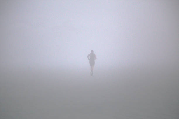 istock Dense fog on the beach, silhouette running man 2167258178