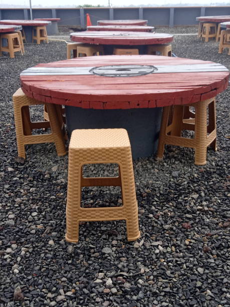 istock round wooden table and plastic chairs for gathering 2167261047
