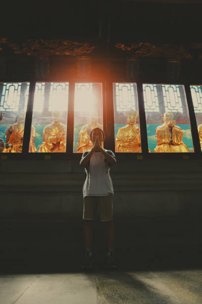 Boy worships Buddha, in the temple