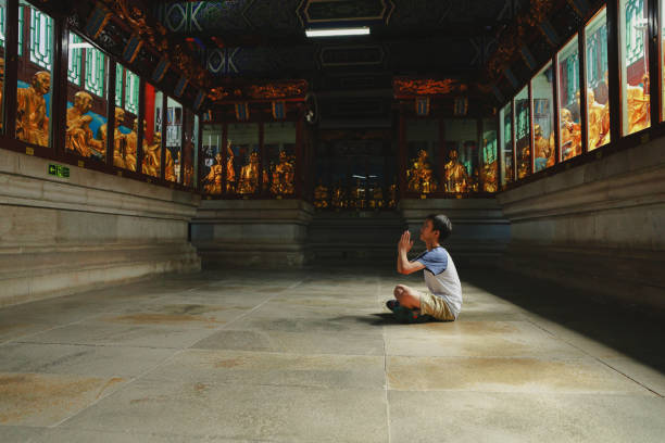 Boy worships Buddha, in the temple