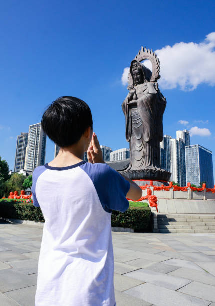 Boy worships Buddha, in the temple