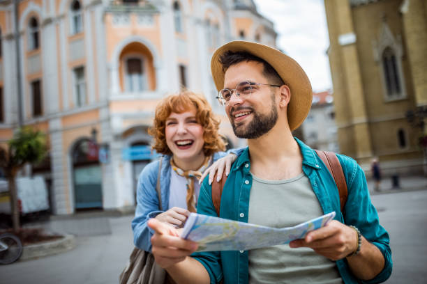 istock Young couple using a map to explore the new city on their vacation. 2167263481