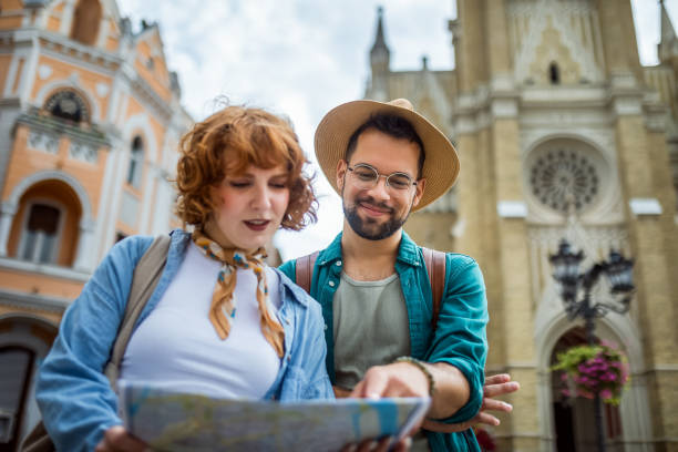 istock Young couple using a map to explore the new city on their vacation. 2167263487