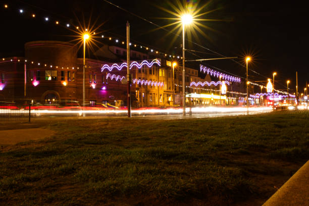 Night cityscape with light trails from moving vehicles and illuminated buildings, showcasing urban nightlife and motion in Blackpool, England