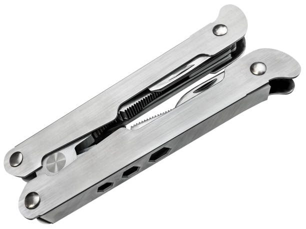 Studio shot of assembled vintage multi function stainless steel pocket tool kit, with 14 different functions tools, isolated on white background, high angle side view, high resolution stock image.