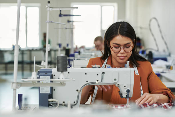 istock Seamstress sewing apparel by workplace 2167270083