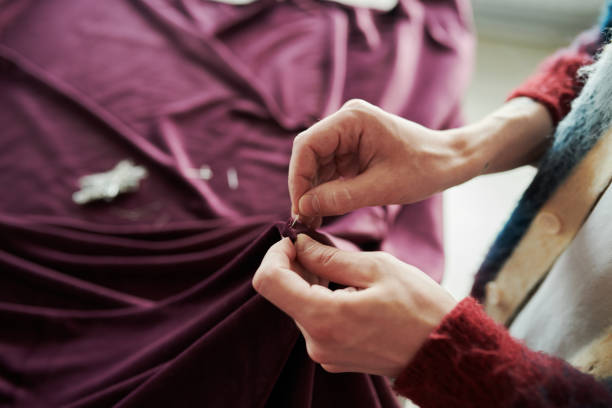 istock Pinning edges of unrolled purple textile 2167270184