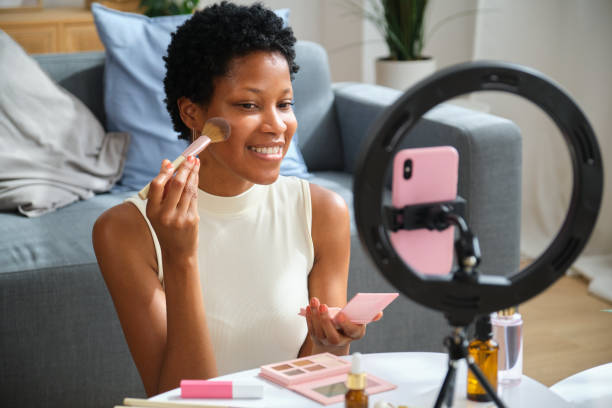 istock Beauty blogger applying makeup using smartphone ring light 2167271118