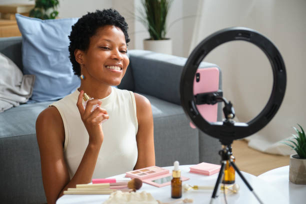 istock Beauty influencer applying perfume while recording video blog 2167271175
